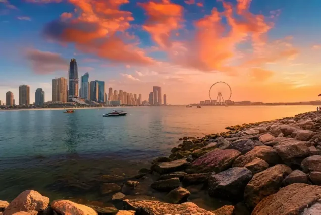 Sunset view of Dubai's skyline from the water, showcasing the city's iconic architecture during a city tour.